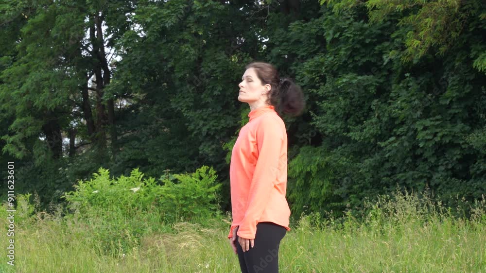 Woman makes exersices in the morning before jogging Woman makes exersices in the morning before jogging