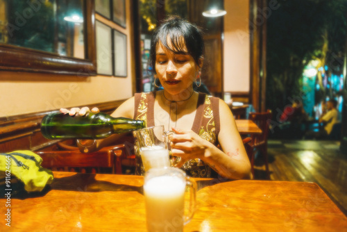 Woman Pouring Drink in a Bar photo