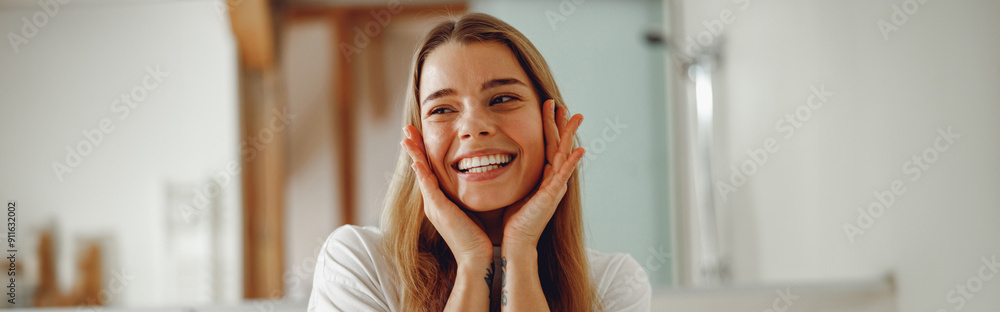Attractive woman touching her pretty face and smiling while standing in bathroom Attractive woman touching her pretty face and smiling while standing in bathroom