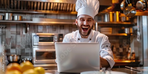 elated chef using laptop, commercial kitchen background, copy space