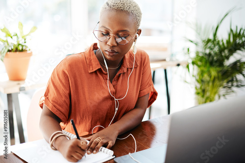 Canvastavla Office, creative and black woman with earphones, writing in notebook and laptop for transcription of web ideas
