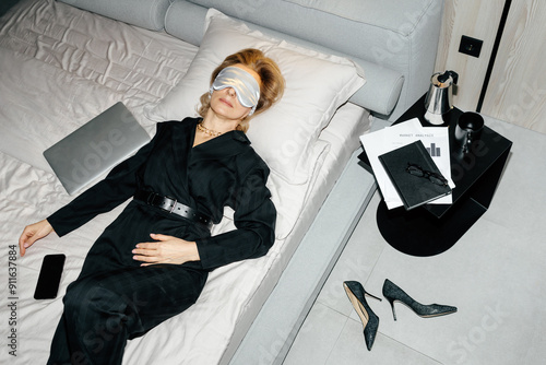 Tired businesswoman on bed after hard work day