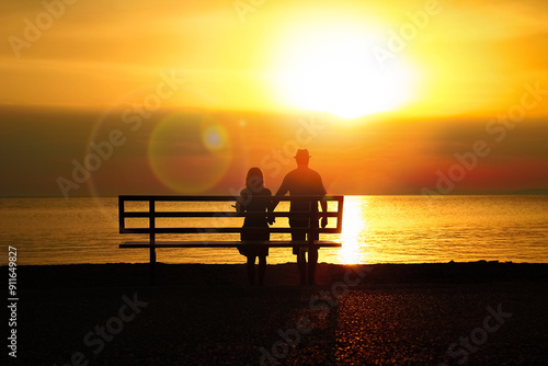 A happy couple on a bench by the sea on nature in travel silhouette