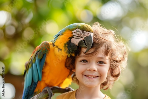 A parrot sits on the shoulders of a child who is smiling photo