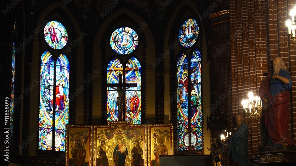 Obraz premium The interiors of a cathoric church in Szczecin (Roman Catholic Parish of St. John the Baptist) with stained glass window