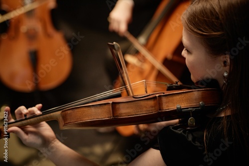 Fotografía Cropped side view shot of unrecognizable female musician playing violin with str