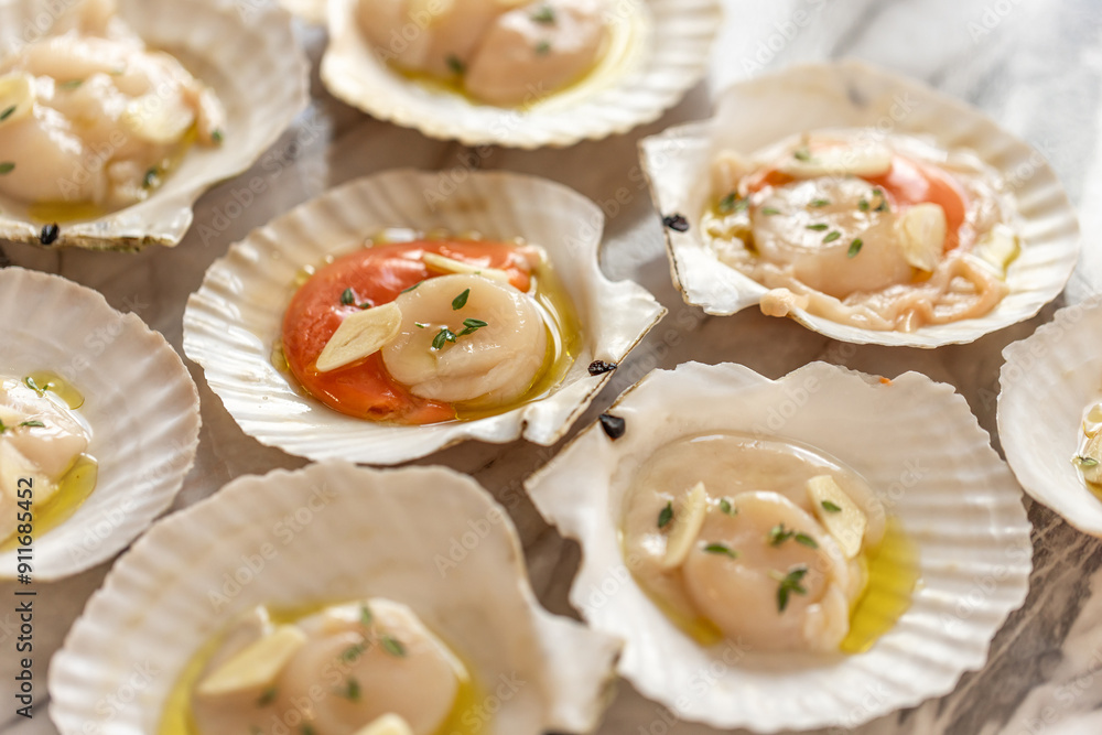 scallops cooked with thyme, garlic and olive oil for baking in the oven scallops cooked with thyme, garlic and olive oil for baking in the oven