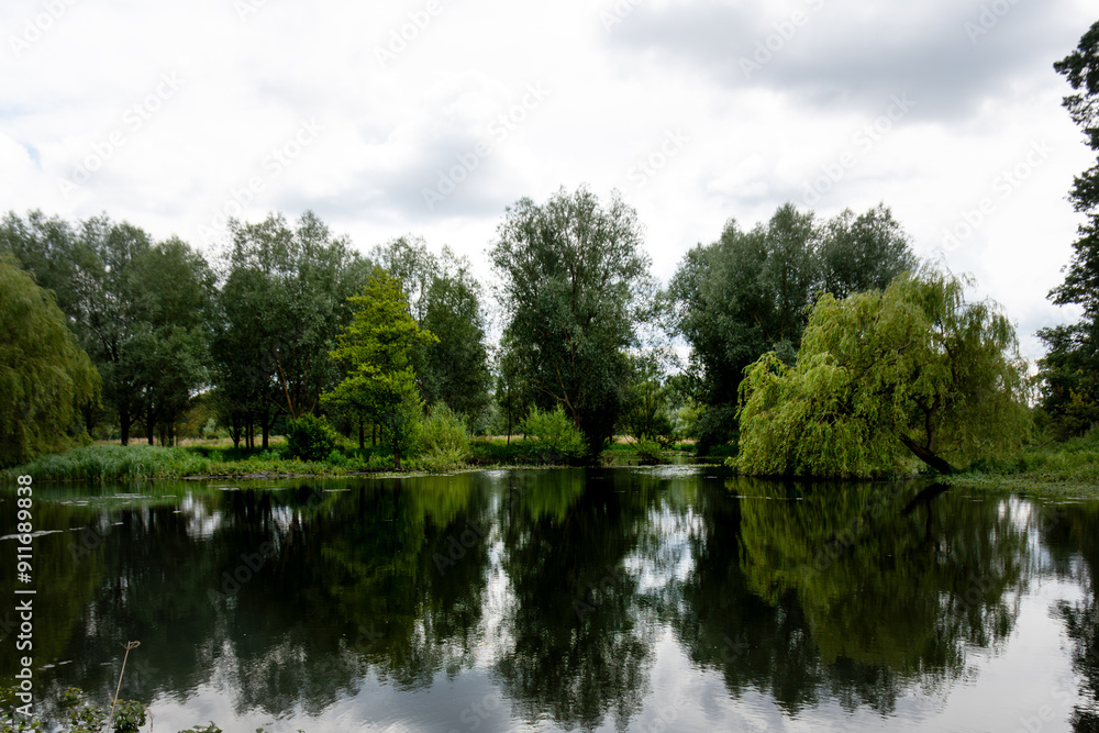 Small treelined lake with reflection Small treelined lake with reflection