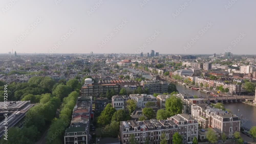 Breathtaking aerial perspective of Amsterdam, featuring its famous canals, green parks, historic architecture, and vibrant cityscape Breathtaking aerial perspective of Amsterdam, featuring its famous canals, green parks, historic architecture, and vibrant cityscape