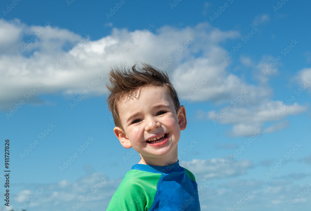 Happy vacation portrait of child against blue sky and clouds Happy vacation portrait of child against blue sky and clouds