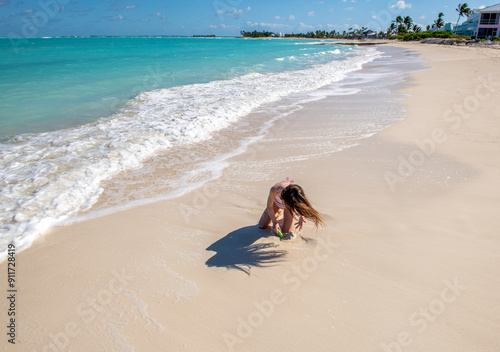 Child plays on the beach in Treasure Cay, Great Abaco Island, Bahamas photo