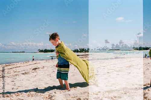 Boy on beach w towel, accidental Double exposure vacation film photo