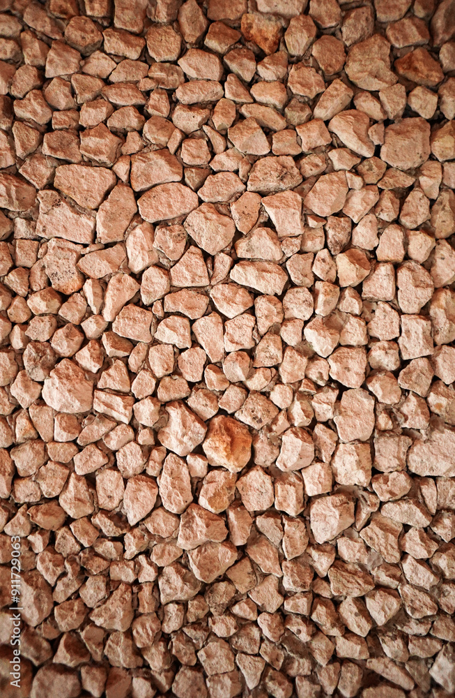 Brown stone on the wall. Stone designs with pebbles at wall.Vertical. Brown stone on the wall. Stone designs with pebbles at wall.Vertical.