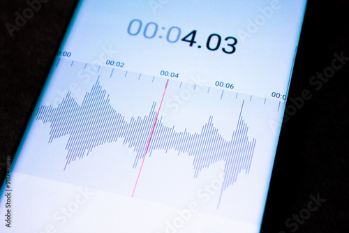 Voice recorder on a smartphone. Voice recording wave on the screen of a smartphone. Recording sounds on a smartphone. Voice recorder noise level wave.