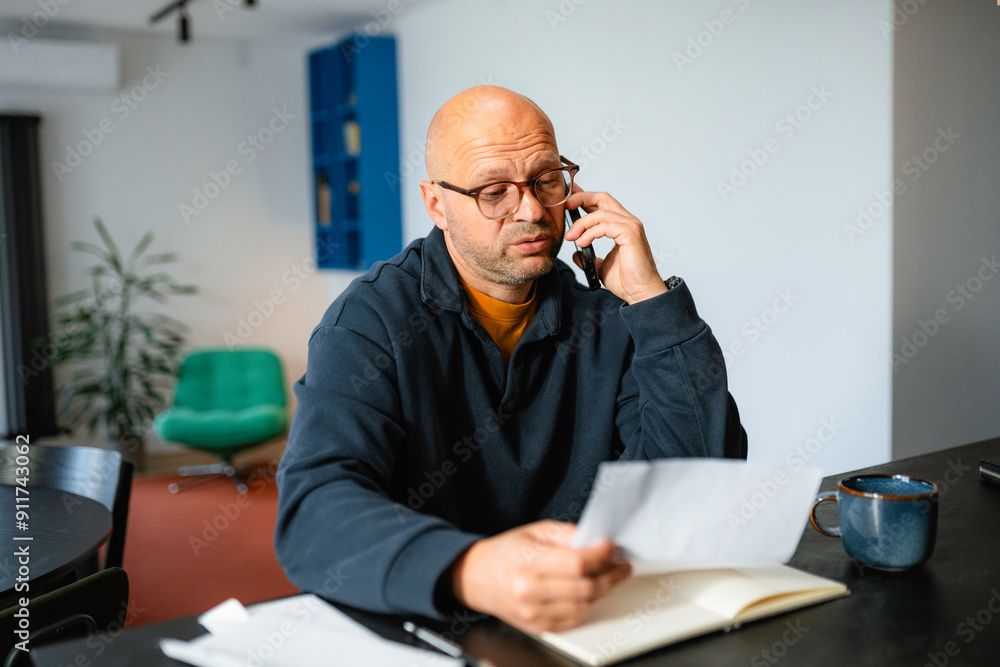 A man is talking on his mobile phone A man is talking on his mobile phone