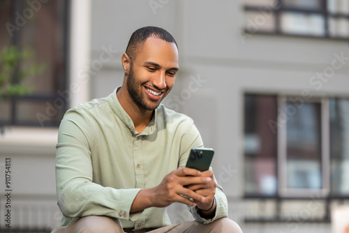 Emotional man browsing website in social media using smartphone on city street