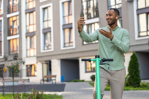 Wallpaper Mural African American man in casual clothing riding electric scooter and enjoying online communication Torontodigital.ca