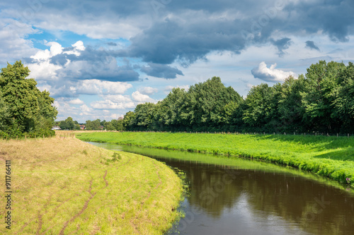 The Hase river and green surroundings on a sunny day in Löningen, Lower Saxony, Germany