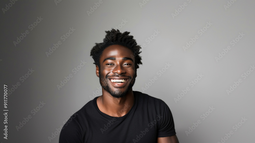 A handsome black man with freckles smiling while looking into the camera. 