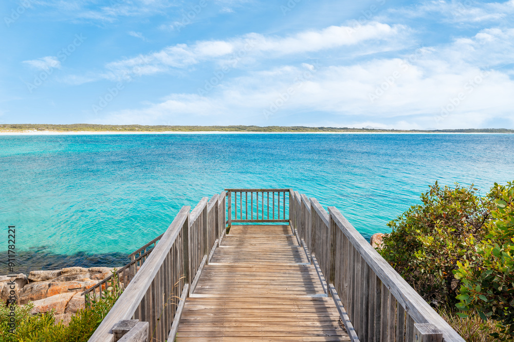 Wooden platform leading to turquoise bay in summer Wooden platform leading to turquoise bay in summer