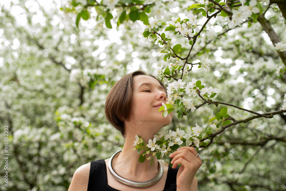 Young woman smelling apple blossom Young woman smelling apple blossom