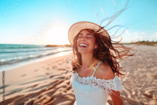 Portrait of a young woman on the beach smiling with her eyes closed, relaxing on a summer vacation.