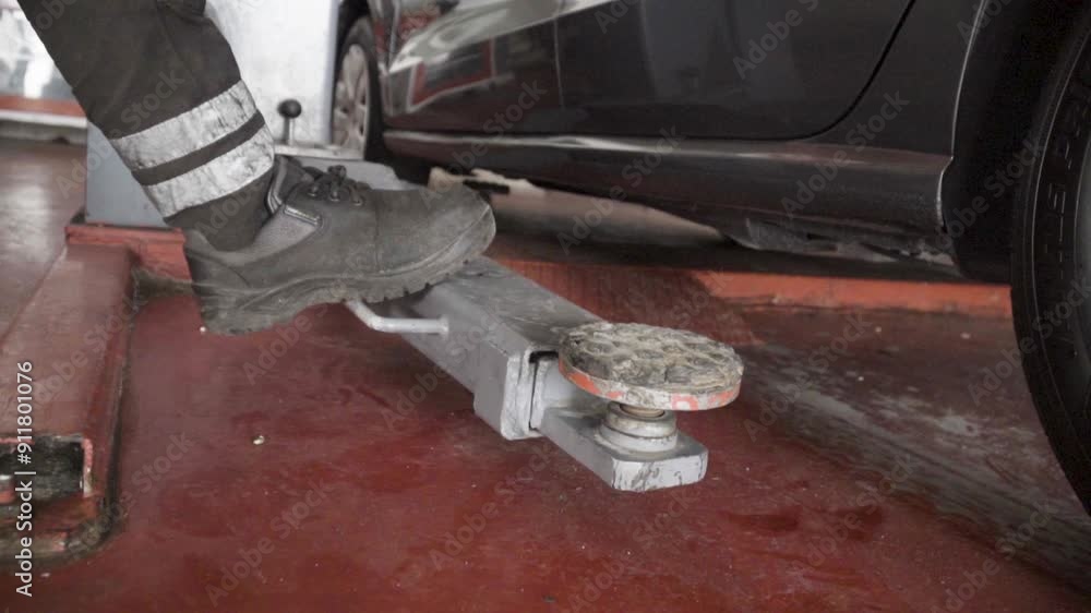 industrial video shot,Lifting Up, A Close-Up of a Mechanic Using a Car Jack, industrial video shot,Lifting Up, A Close-Up of a Mechanic Using a Car Jack,