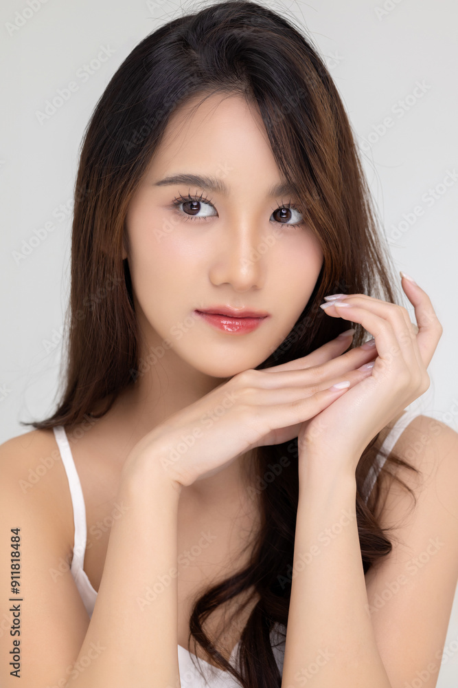 Beautiful young Asian woman with natural beauty make up style shows healthy and perfect skin on isolated background. Facial and skin care concept for commercial advertising. Beautiful young Asian woman with natural beauty make up style shows healthy and perfect skin on isolated background. Facial and skin care concept for commercial advertising.