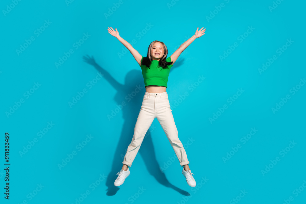 Full body portrait of pretty young girl jump wear t-shirt isolated on turquoise color background Full body portrait of pretty young girl jump wear t-shirt isolated on turquoise color background