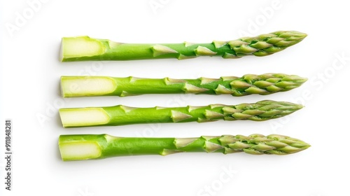 Fresh asparagus spears cut in half lengthwise, revealing the delicate inner layers and texture. Isolated on a clean white background photo