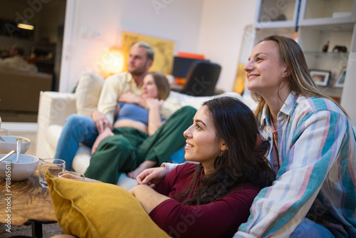 Two couples watching movies at home photo