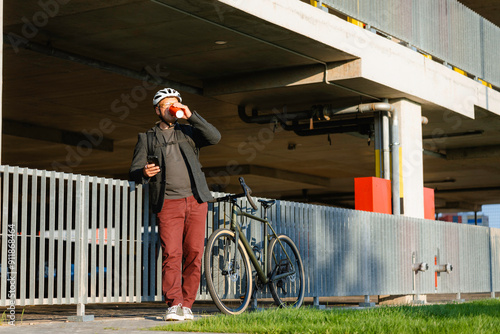 A cyclist uses a mobile phone photo