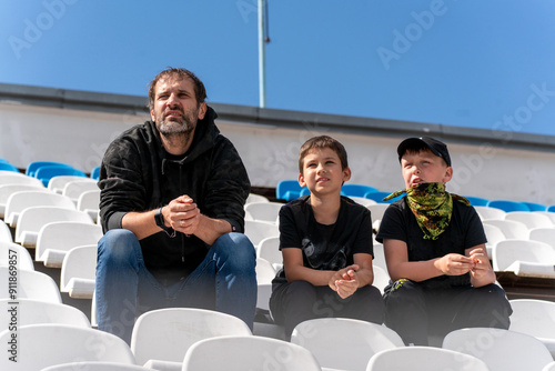 father and sons sports fans