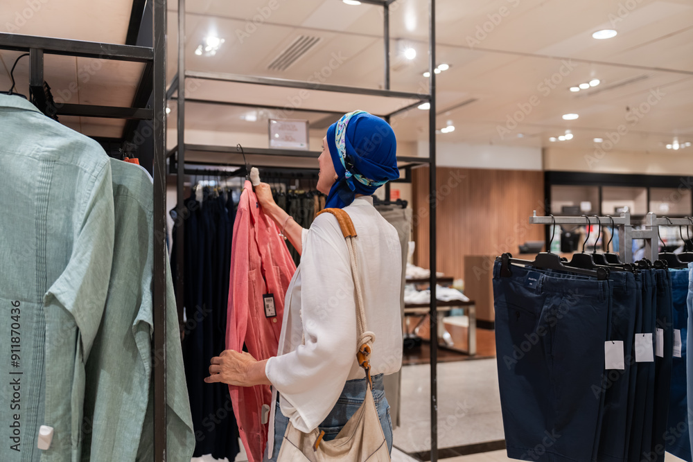 woman shopping for clothes in a retail store woman shopping for clothes in a retail store