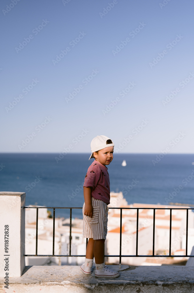 Boy in white cap overlooking the mediterranean sea Boy in white cap overlooking the mediterranean sea