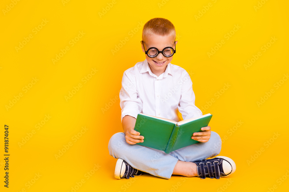 Photo of clever intelligent charming cheerful funny boy wear white shirt sit floor isolated on yellow color background Photo of clever intelligent charming cheerful funny boy wear white shirt sit floor isolated on yellow color background