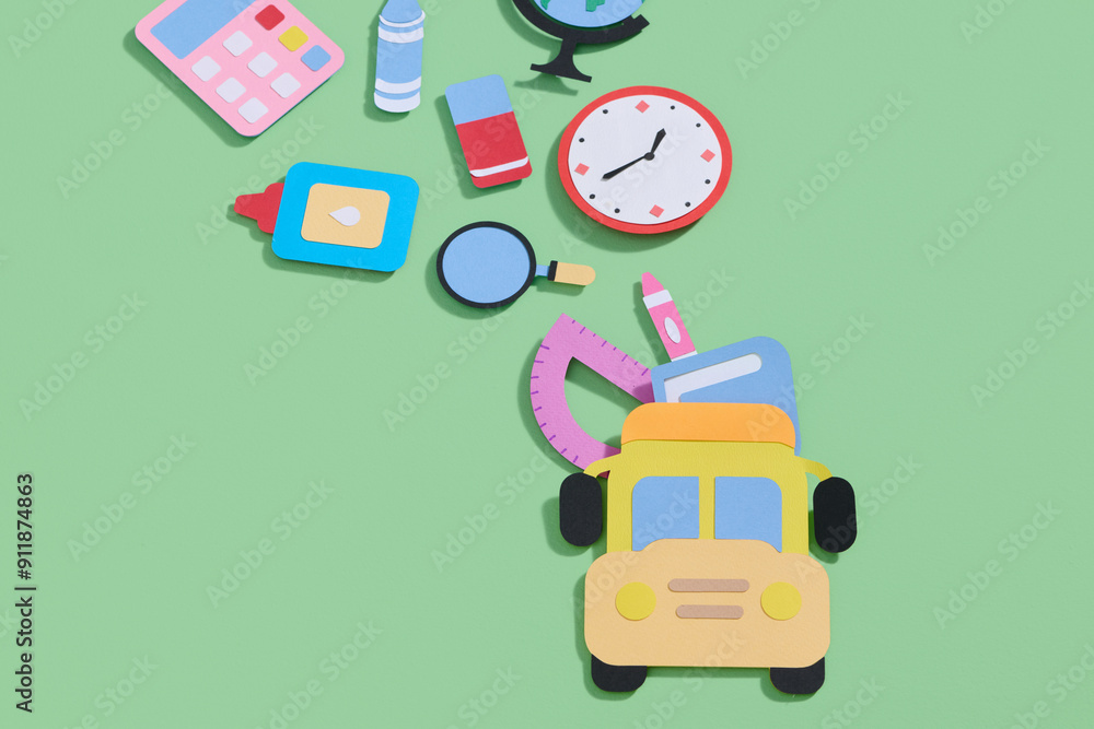 Colorful School Supplies and Bus Paper Craft on Green Background Colorful School Supplies and Bus Paper Craft on Green Background