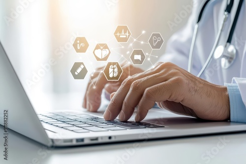 A healthcare professionals hand in a white coat using a laptop photo