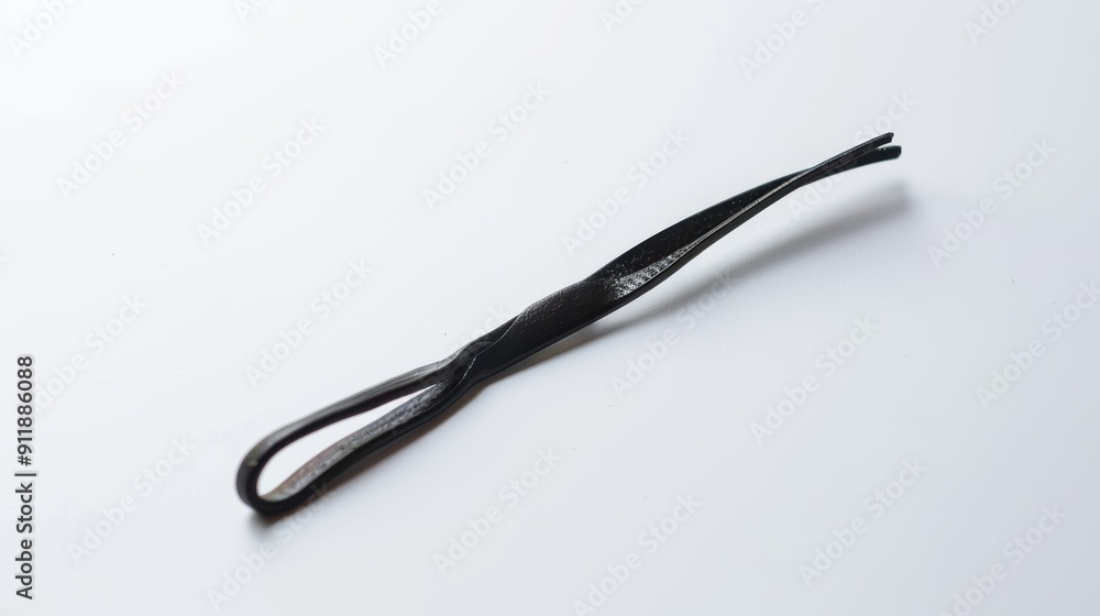 Sleek black metal hairpin on a white background, adding elegance to any hairstyle for a stylish woman. Perfect for salon or night out Sleek black metal hairpin on a white background, adding elegance to any hairstyle for a stylish woman. Perfect for salon or night out