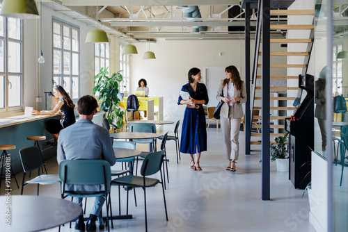 Managers walking and discussing in a modern coworking space photo