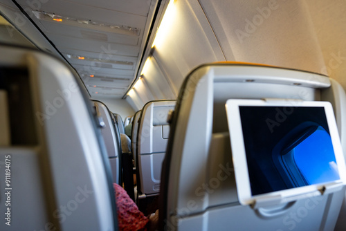 Using digital tablet in airplane for enertainment and work, no people photo