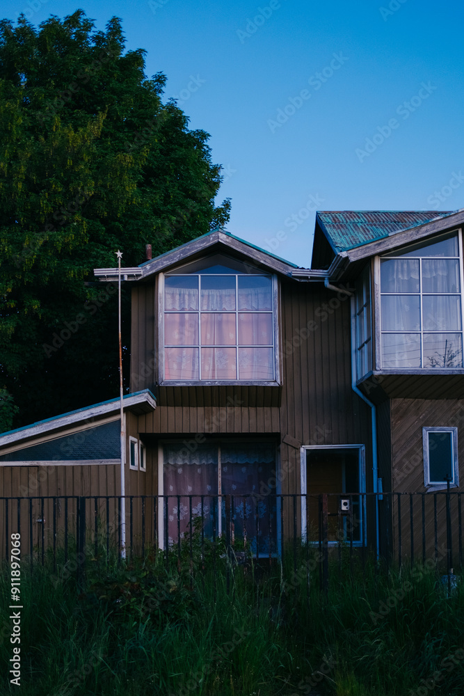 Sunset reflecting on old house windows Sunset reflecting on old house windows