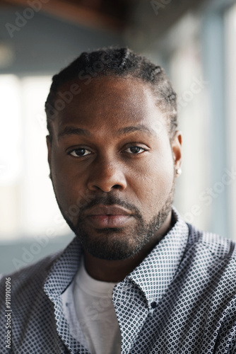 Man stares sternly at camera with soft eyes photo