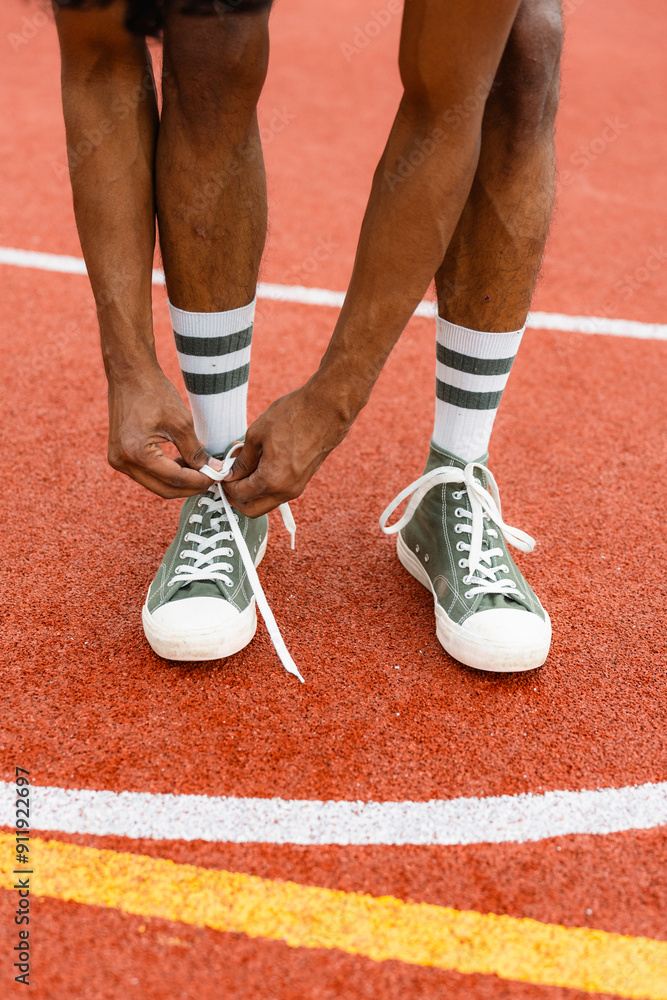 A basketball player ties his shoelaces A basketball player ties his shoelaces