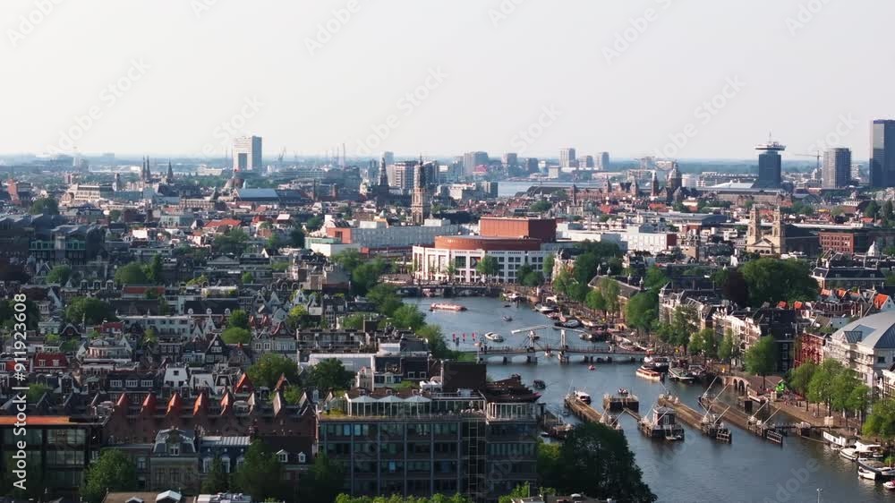 Amsterdam's canals and historic buildings from above in this aerial view. City's urban landscape on a sunny day Amsterdam's canals and historic buildings from above in this aerial view. City's urban landscape on a sunny day