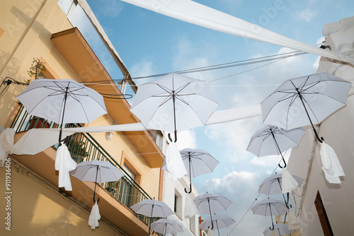 White Umbrellas Hanging Over Street photo