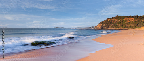 Blue skies golden sands and warm ocean coastline in Sydney