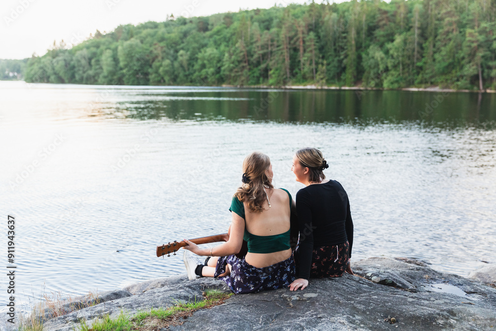 Teenage Friends Enjoying Guitar by the Lake Teenage Friends Enjoying Guitar by the Lake