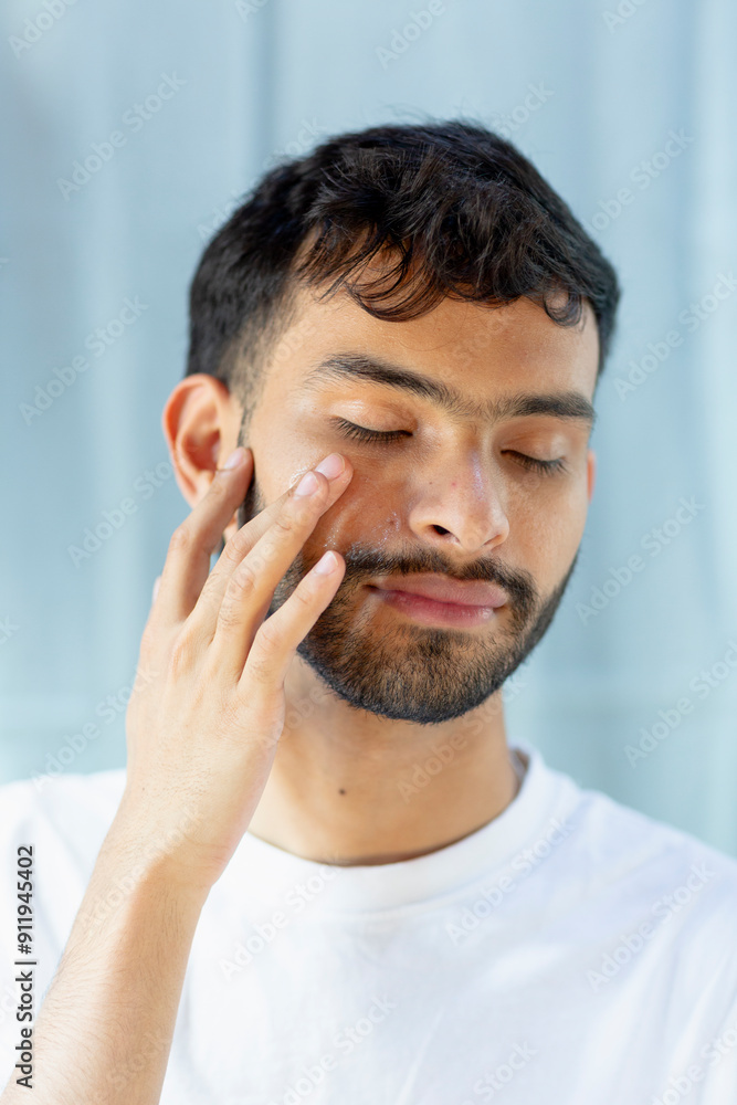 Bearded Man applying product on skin Bearded Man applying product on skin