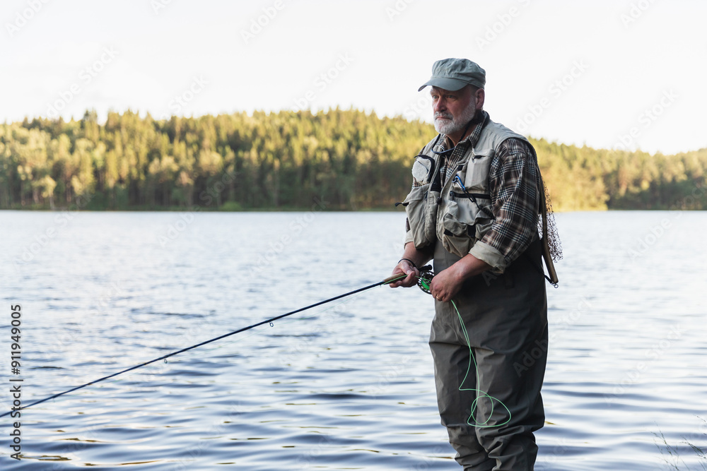 Fisherman Standing in Lake Amidst Scenic Wilderness Fisherman Standing in Lake Amidst Scenic Wilderness